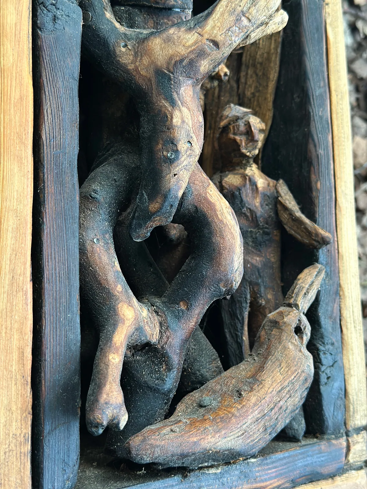 Detail: the carved figures inside the box.