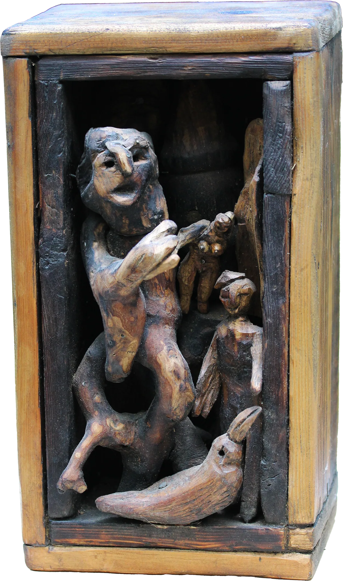 Small wooden box assemblage with carved figures inside: a standing creature, a smaller figure and a bird.