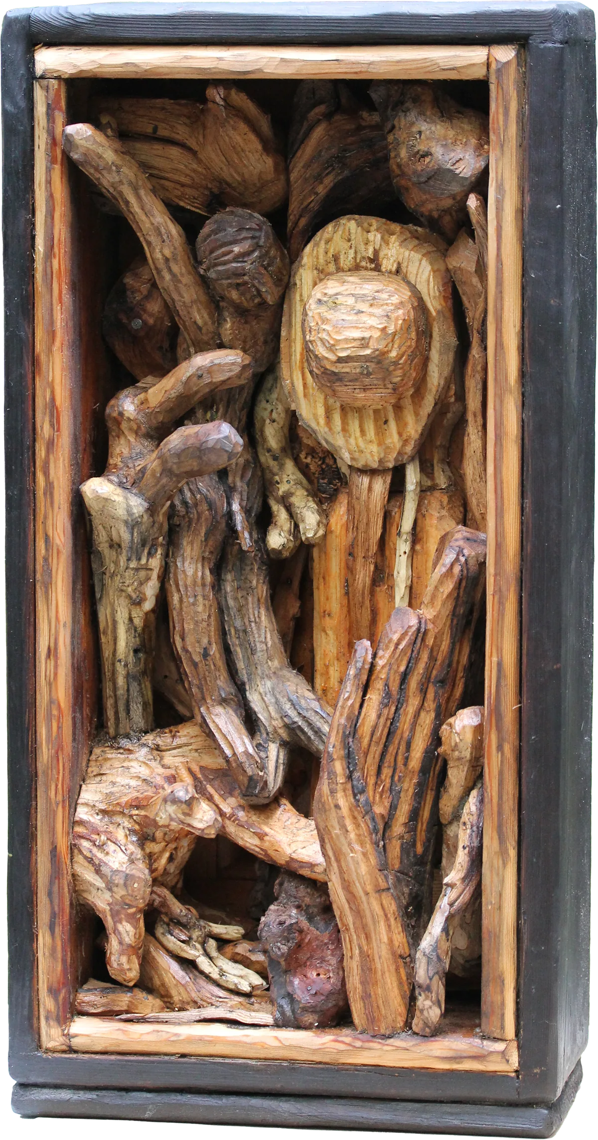 Tall wooden box assemblage filled with carved and found wood forms, like figures and seed heads crowded together.