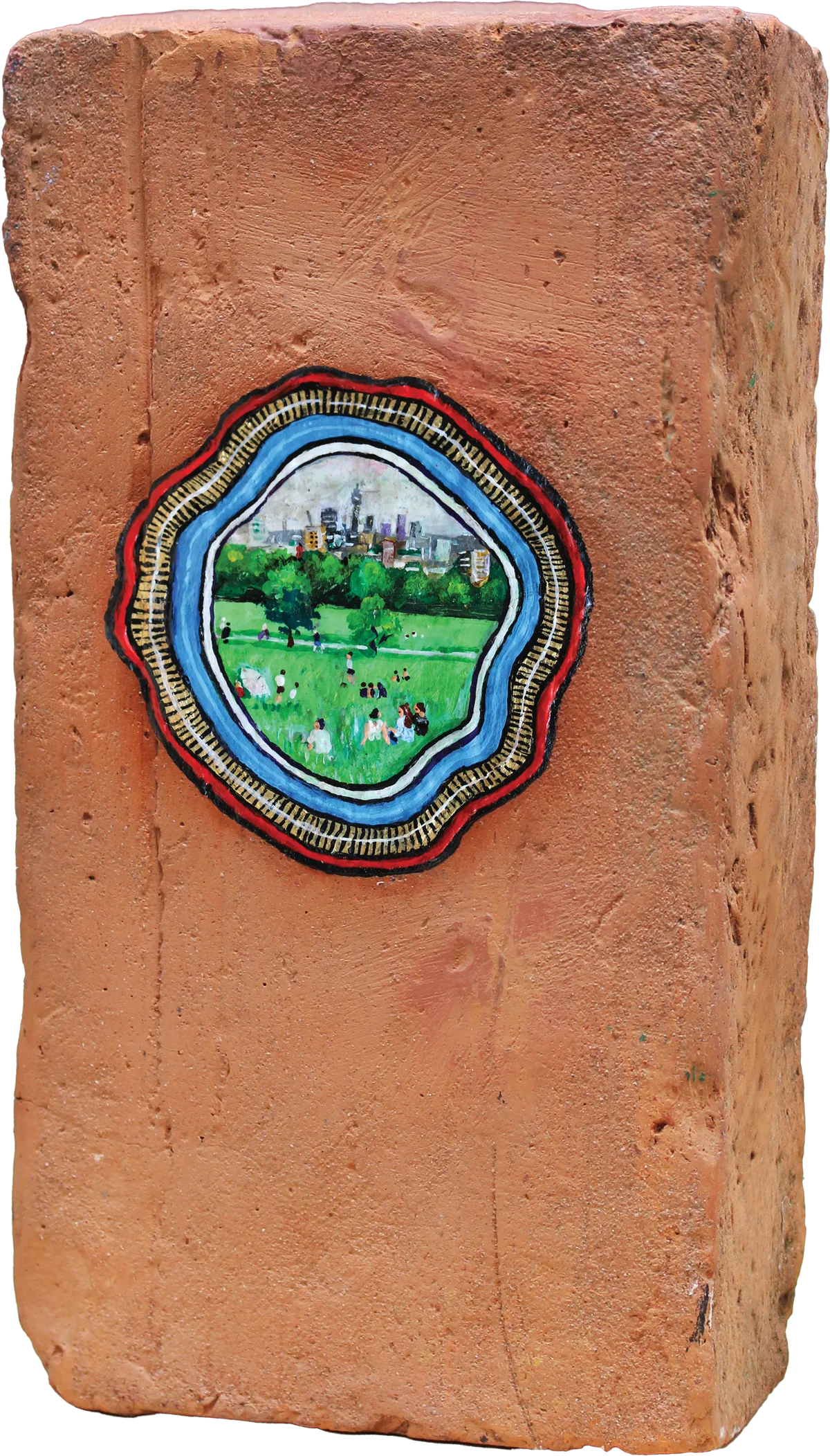 A red brick with a tiny painting on a piece of chewing gum at its centre, ringed in blue and red, showing Parliament Hill.